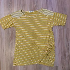 Mustard yellow shirt with white stripes.